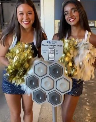 image of the electron to go charging station with two dance team students