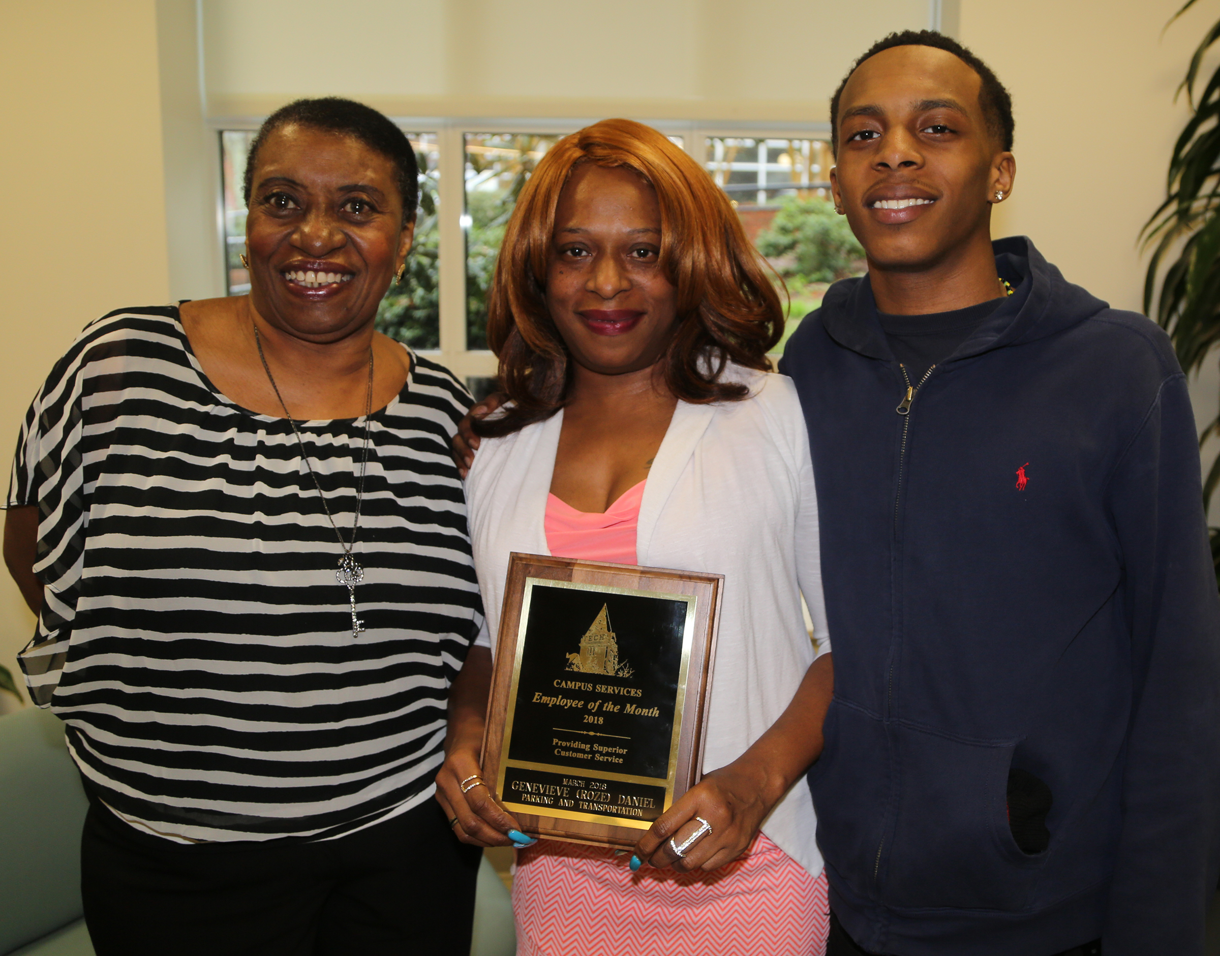 Picture of Roze Daniel, the March 2018 Campus Services Employee of the Month, with her mother and son