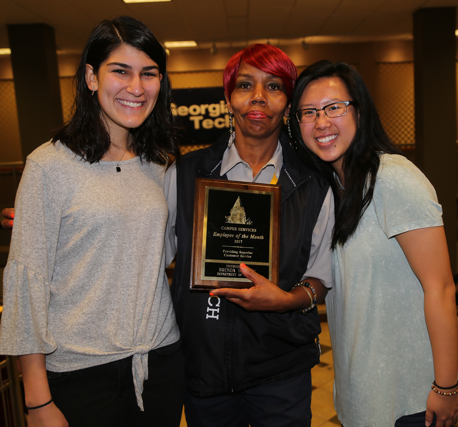 Picture of Brenda Harmon, December 2017 Employee of the Month, with two of the students who live in the residence hall where she works - (l-r) Nadin Kosedag (BA major) and Jere Tan (BMED major).